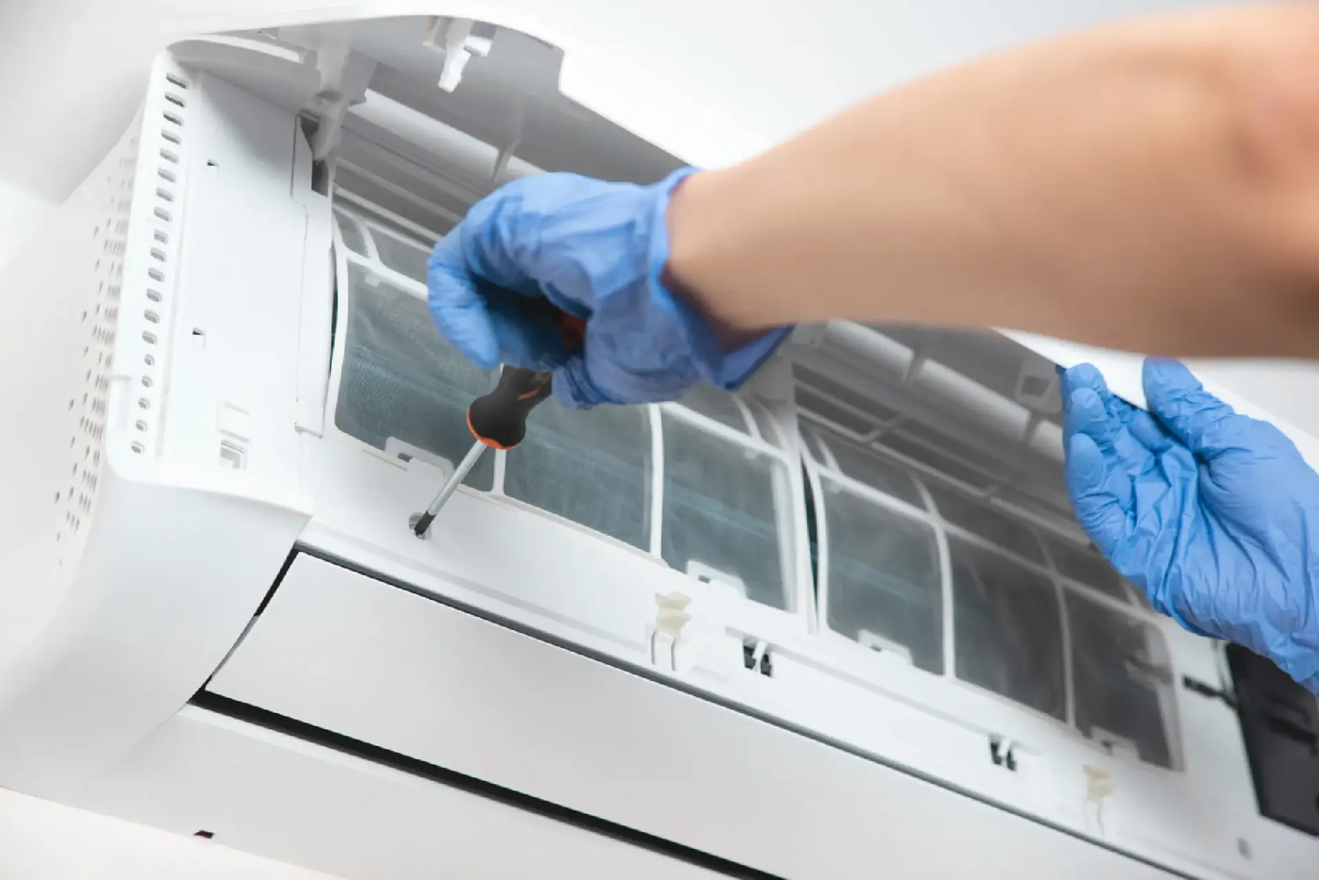 Technician installing a split air-conditioning unit
