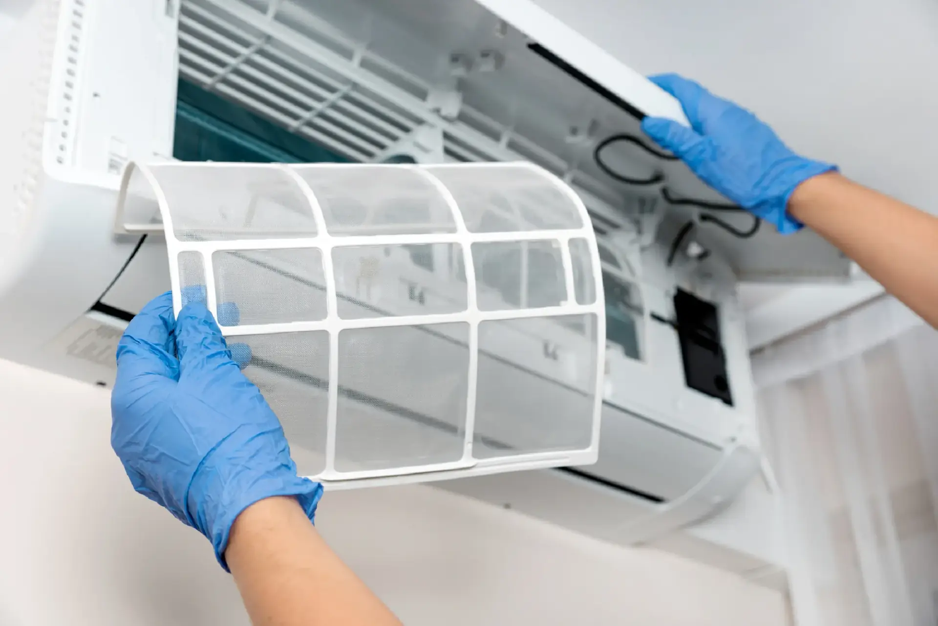Air-conditioning filter being removed for cleaning